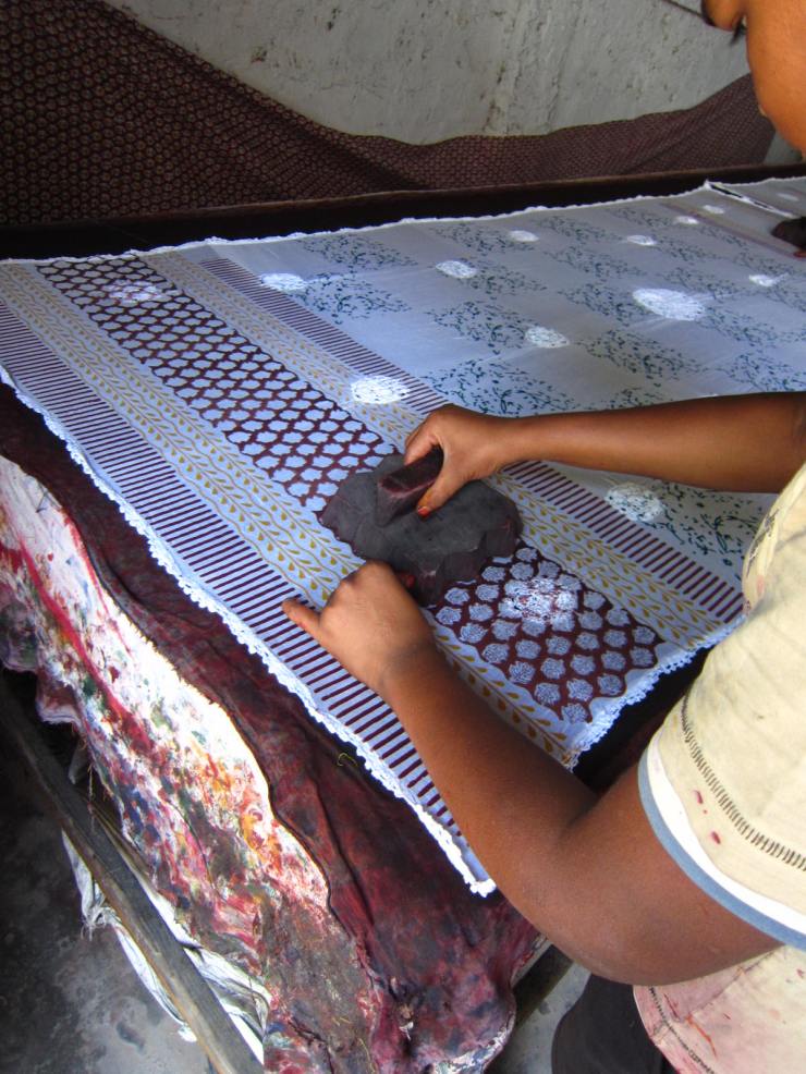 Each pattern on the textile uses a different stamp, applied in a layered pattern.